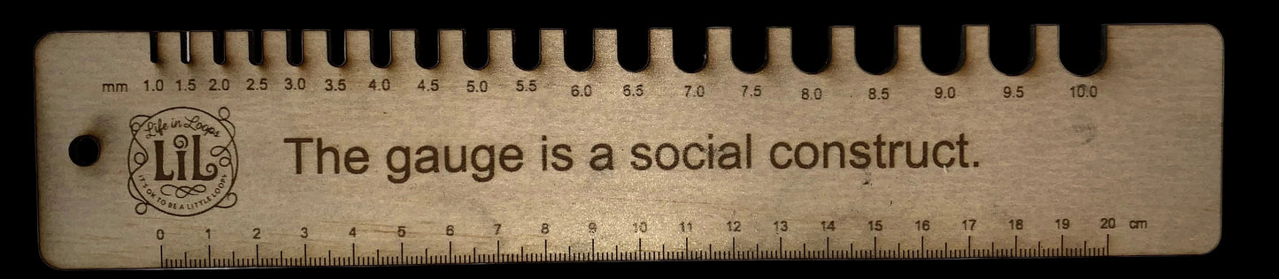 Wooden ruler with engraved text on a white background