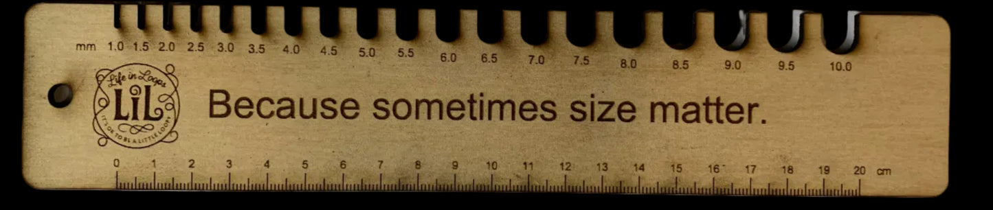 Wooden ruler with text 'Because sometimes size matters' on a white background