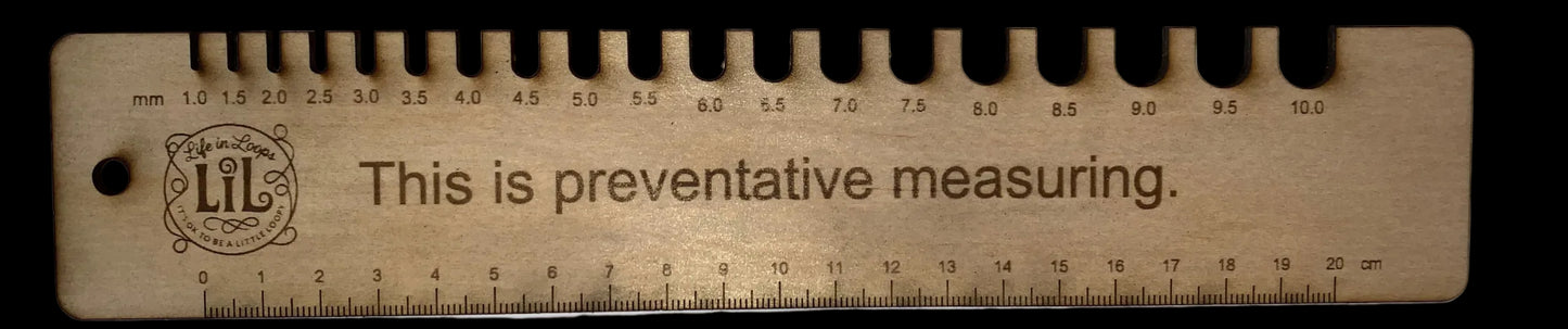 Wooden ruler with engraved text on a white background